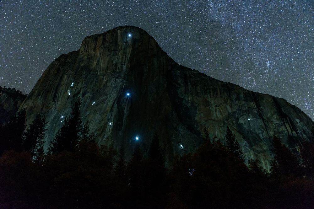 Stars at night and climbers lights on El Capitan